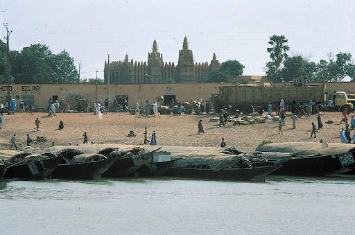People walking past the Niger River in Mopti.